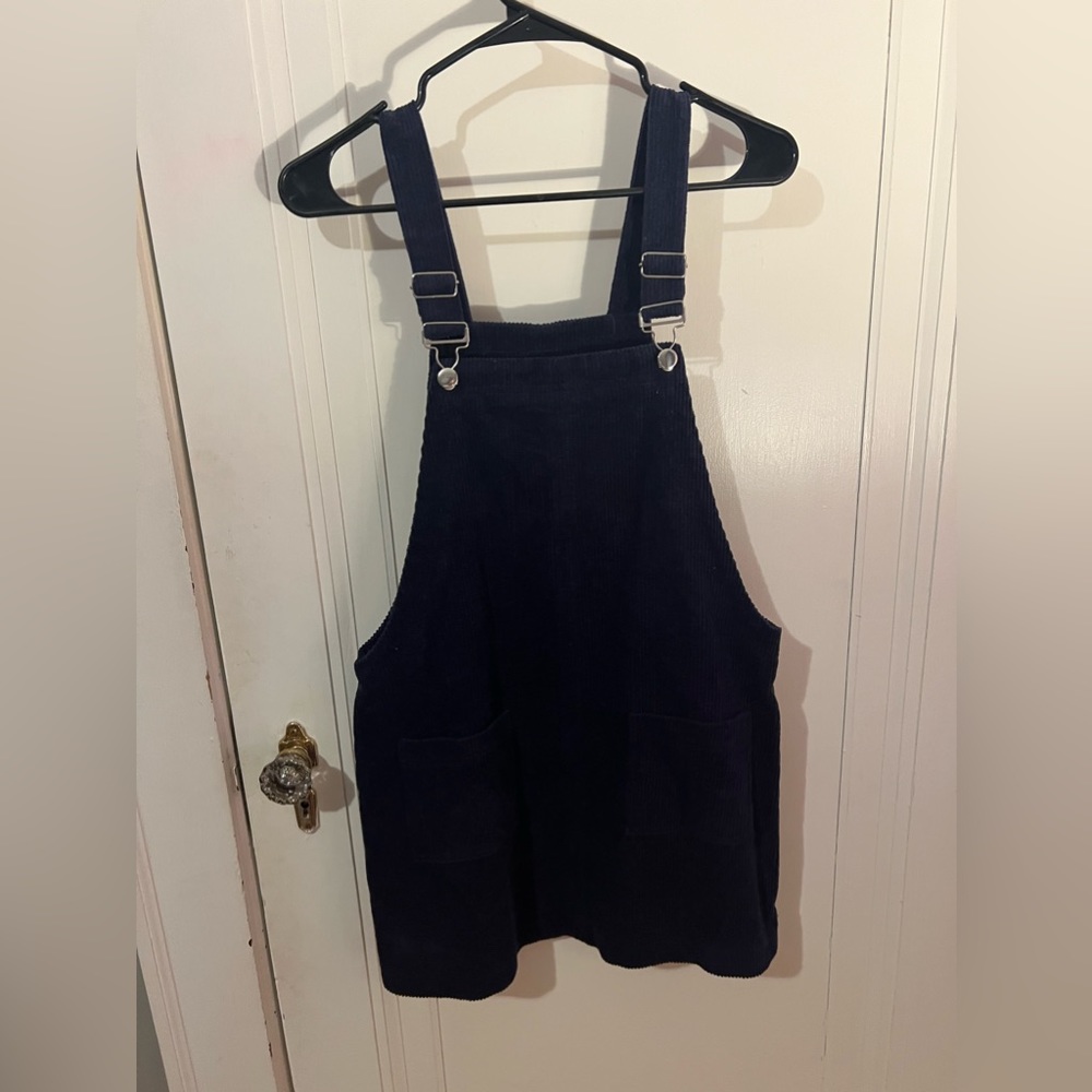 Overalls dress. Dark blue, corduroy, medium. Two pockets in front.